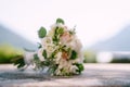 Pair of wedding rings stands against the background of the bridal bouquet Royalty Free Stock Photo