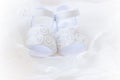 Pair of white baby shoes , christening white dress