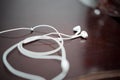 White earphone on the wooden table