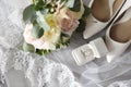 Pair of white high heel shoes, veil, rings and wedding bouquet on grey background, flat lay Royalty Free Stock Photo