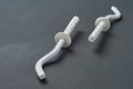 Pair of white new modern hooks for mount aluminum or bimetallic radiator for heating house