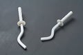 Pair of white new modern hooks for mount aluminum or bimetallic radiator for heating house