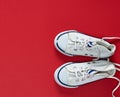 Pair of white old textile sneakers with untied laces Royalty Free Stock Photo