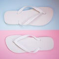 a pair of white sandals on pink and blue pastel background. Lover and Summer concept Royalty Free Stock Photo