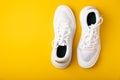 A pair of white shoes on a yellow background. Royalty Free Stock Photo