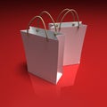 Pair of white shopping bags on a red background