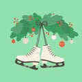 A pair of white skates are hanging on the wall with New Year holiday decorations.