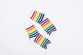 Pair of white socks with colorful striped pattern on white background. Copy space Royalty Free Stock Photo