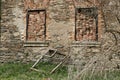 Pair of windows with bricks in frames and old window frame in grass Royalty Free Stock Photo