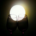 A pair of wine glasses and a bright light Royalty Free Stock Photo