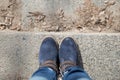 Pair of winter boots on female legs on stairs Royalty Free Stock Photo