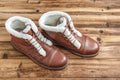 A pair of winter brown boots on a wooden background