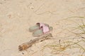 Pair of woman sandals in tropical, sandy beach Royalty Free Stock Photo