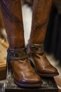 Pair of women`s brown leather boots designed in western style disp