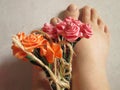 A Pair Of Women`s Feet With A Flower Arrangement Royalty Free Stock Photo