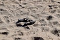 Pair of women\'s sandals on the beach sand Royalty Free Stock Photo