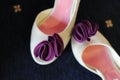 Pair of women`s shoes, elegant white leather footwear with a purple suede bow