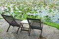 Pair of Wooden Chairs on Water Lilies Pondside