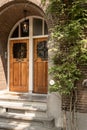 a pair of wooden doors on a brick building