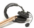 Pair of wooden drumsticks with Black Head phones.