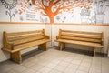 Pair of wooden park benches inside a public building