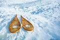 Pair of wooden snowshoes from above lay in the snow