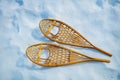 Pair of the wooden snowshoes in snow view from above