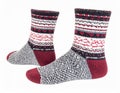 Pair of Wool Socks with Intricate Patterns Red Gray Black and White Colors on White Background Royalty Free Stock Photo