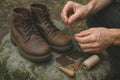 Repairing Leather Boots by Hand with Thread and Patches Outdoors Royalty Free Stock Photo