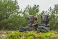 A pair of worn hiking boots on natural background. Dirty boots for hiking, fishing, traveling