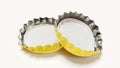 Pair of yellow beer caps on white background