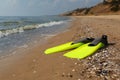 Pair of yellow flippers on sand near sea. Space for text Royalty Free Stock Photo