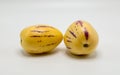 2 ripe pepino melons on white