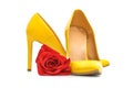 A pair yellow of  women`s heel shoes with red rose isolated on white background Royalty Free Stock Photo