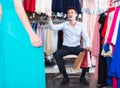 pair of young interested people in women clothes boutique