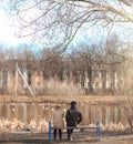 A pair of young people met in the park. Lovers are sitting on a Royalty Free Stock Photo