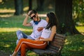 A pair of young people met in the park. Lovers are sitting on a bench Royalty Free Stock Photo