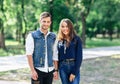 Pair of young people standing in park and hold hands Royalty Free Stock Photo