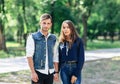 Pair of young people standing in park and hold hands Royalty Free Stock Photo