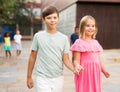 Pair of young people walking hand in hand