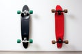 paired, identical skateboards leaning against a white wall