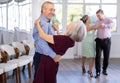 Pairs of mature amateur dancers enthusiastically performs romantic tango dance in dance salon Royalty Free Stock Photo