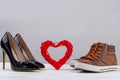 Pairs of mens and womens shoes with red heart. Royalty Free Stock Photo