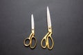 Pairs of scissors gold handle isolated on black background, top view