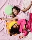 Pajama party and childhood concept. Girls lie on bed sheets Royalty Free Stock Photo