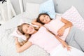 Pajama party and friendship. Sisters happy small kids relaxing in bedroom. Friendship of small girls. Leisure and fun Royalty Free Stock Photo