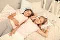 Pajama party and friendship. Sisters happy small kids relaxing in bedroom. Friendship of small girls. Leisure and fun Royalty Free Stock Photo