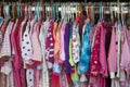 Second hand clothes in thrift shop night wear pajamas for kids girl pink flannel clothes rack Royalty Free Stock Photo