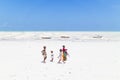 Paje, Zanzibar - Feb 9, 2015: Local kids walking at Paje village picture perfect white beach at low tide on February 9th