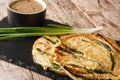 Pajeon Korean Scallion Pancakes with sauce close-up on a slate board. Horizontal